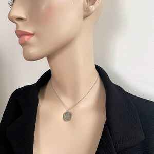 cute silver coin pendant, 15inch choker length, shown worn by model, minimalist look. Slim belcher rolo chain, coin has minimalist silver frame so coin looks effortlessly suspended on chain.