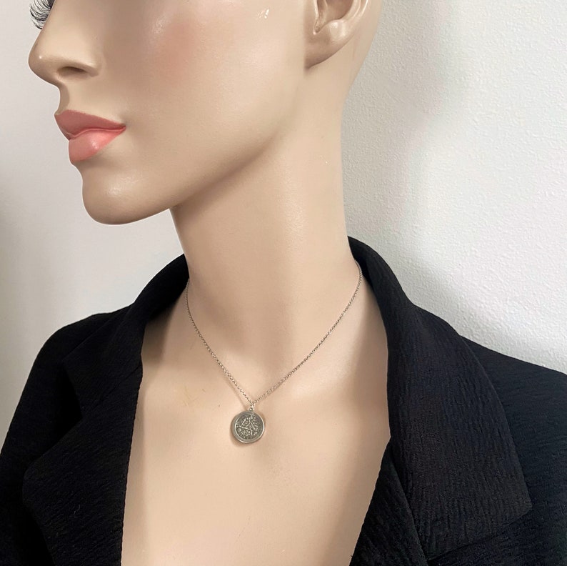 cute silver coin pendant, 15inch choker length, shown worn by model, minimalist look. Slim belcher rolo chain, coin has minimalist silver frame so coin looks effortlessly suspended on chain.