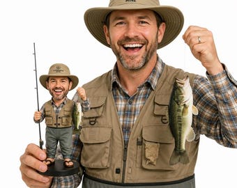 May include: A man wearing a fishing vest and hat holds a fish. A miniature figurine of the man, also holding a fish and fishing rod, is in front of him. The hat has the text "Fisherman Mine".