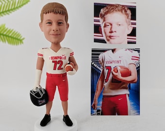 May include: A custom bobblehead figurine of a young person wearing a white and red football uniform with the number 72 on the front. The uniform has the word "VIEWPOINT" on the front. The figurine is holding a football and a helmet. The figurine is standing on a base with the name "Ryan Tinsley" written on it.