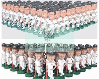 May include: A group of 30 custom bobbleheads of people wearing white jerseys and black hats. The bobbleheads are arranged in a semi-circle shape. The bobbleheads are holding a soccer ball and a baseball bat.