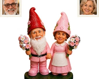 May include: A pair of gnome figurines standing on a green base. The male gnome wears a red hat and pink outfit with a white beard, holding pink and white flowers. The female gnome wears a pink hat and dress with a white apron, holding flowers.