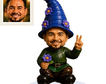 May include: A garden gnome figurine featuring a person's face with a beard, wearing a blue pointed hat decorated with purple flowers. The gnome wears a green tunic with a black belt, brown trousers, and black shoes, holding a purple flower.