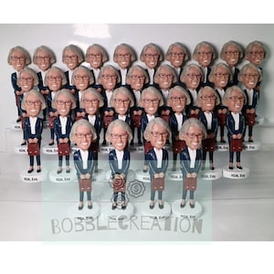 May include: A group of 25 bobbleheads of a person wearing a blue suit and holding a briefcase. The bobbleheads are arranged in rows on a white shelf. The bobbleheads are all identical except for the text on the base, which reads "HGN, Esq."