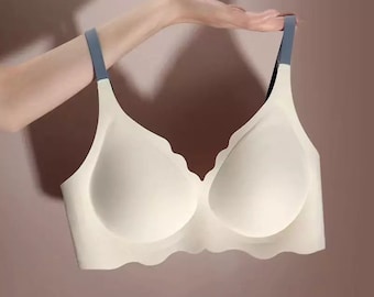May include: A white seamless bra with scalloped edges and adjustable straps. The straps are a light blue color.