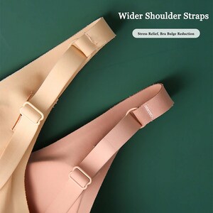 May include: Two close-up images of bra straps with wider shoulder straps. The straps are made of a soft, stretchy material and are designed to provide comfort and support. "Wider Shoulder Straps" and "Stress Relief, Bra Bulge Reduction" are written in the image.