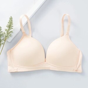 May include: A nude-colored bra with adjustable straps and a smooth, seamless design.