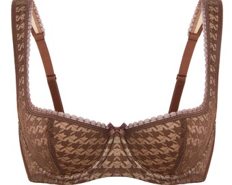 May include: A brown lace bra with a houndstooth pattern. The bra has adjustable straps and a bow in the center.