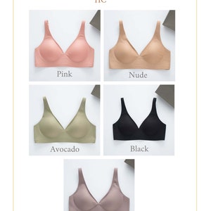 May include: Five seamless bras in different colors: pink, nude, avocado, black, and brown. The bras have a V-neck and adjustable straps.