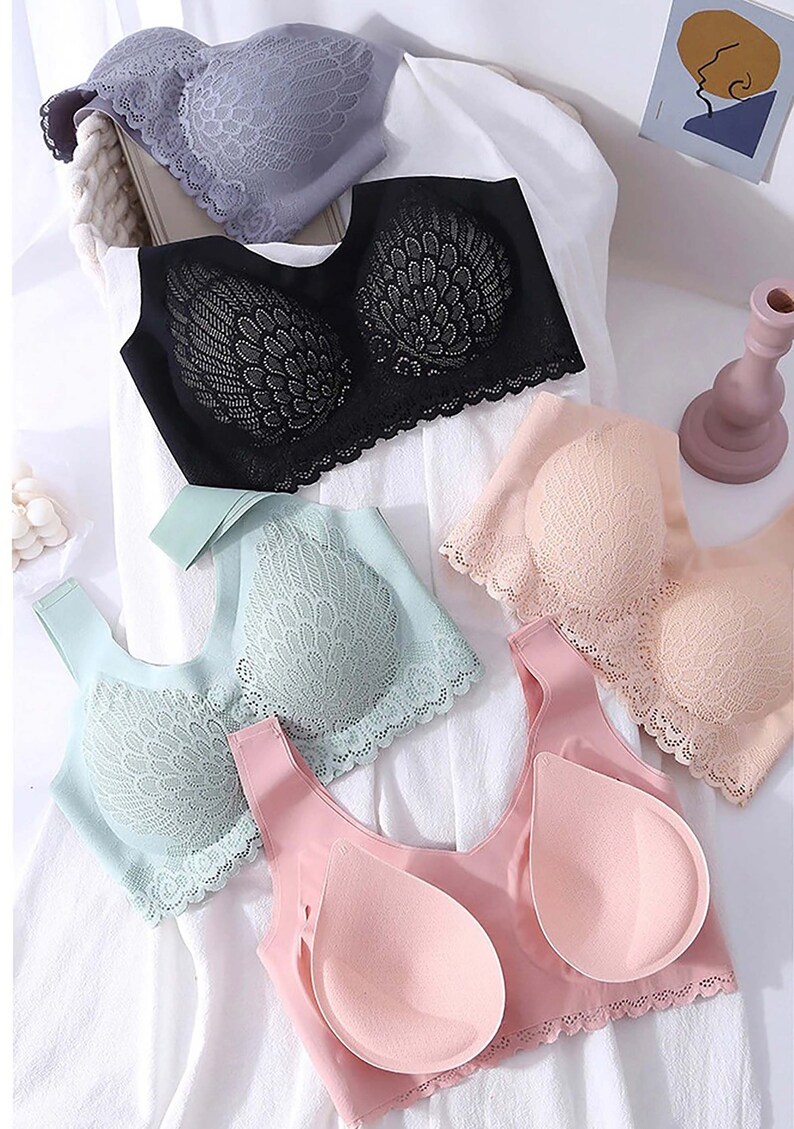 May include: Four different lace bras in various colors, including black, gray, pink, and light blue. The bras have a delicate lace design and are made of a soft, comfortable material.