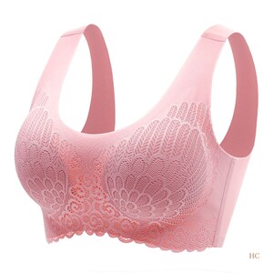 May include: A pink seamless wireless bra with a delicate floral lace pattern. The bra has adjustable straps and a smooth, comfortable fit.