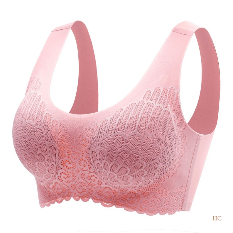 May include: A pink seamless wireless bra with a delicate floral lace pattern. The bra has adjustable straps and a smooth, comfortable fit.