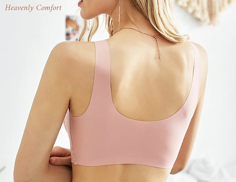 May include: A pink seamless bra with adjustable straps. The bra is made of a soft, stretchy material and has a smooth, comfortable fit.
