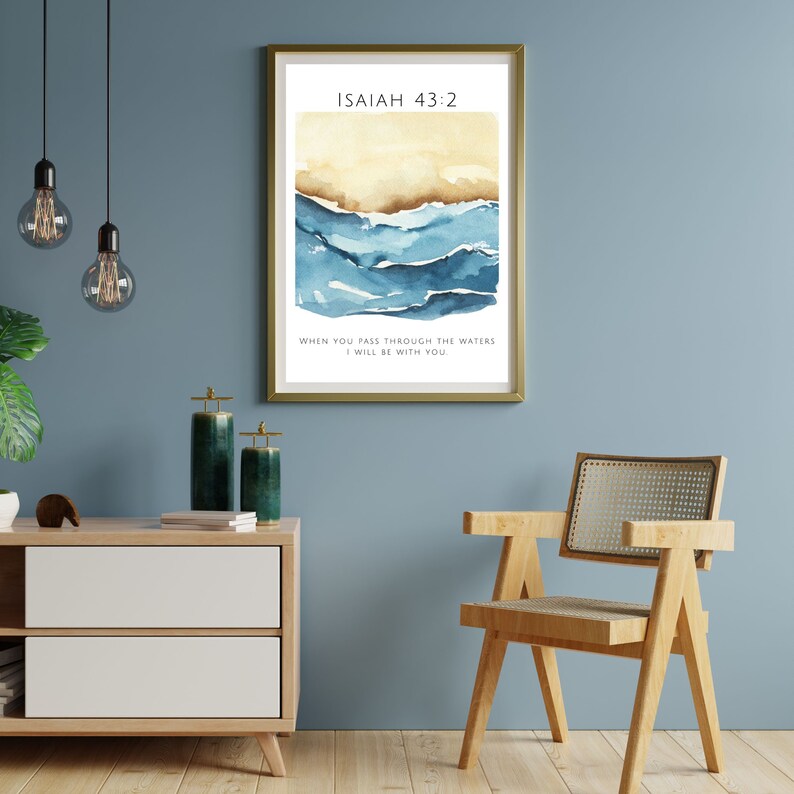 Op de afbeelding: Een aquarel schilderij van blauwe golven met een gouden achtergrond. De tekst "ISAIAH 43:2" staat bovenaan de afbeelding. De tekst "WHEN YOU PASS THROUGH THE WATERS I WILL BE WITH YOU" staat onderaan de afbeelding.