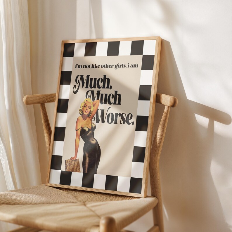 May include: Framed art print featuring a vintage-style illustration of a woman in a black dress, with the text "Much, Much Worse." The print has a black and white checkered border and is displayed on a wooden chair.