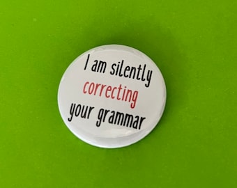 I am silently correcting your grammar.  Pin badge, pocket pebble or magnet. Teacher gift, especially English teacher, pedantic gift