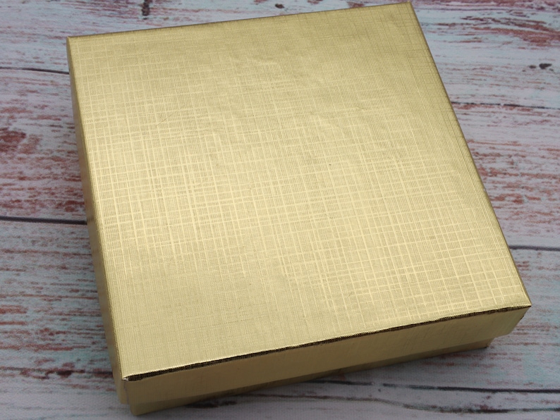 May include: A gold gift box with a textured surface.