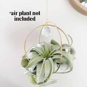 May include: Gold metal hanging planter with two hoops and a crystal prism. The planter is empty, *air plant not included*.