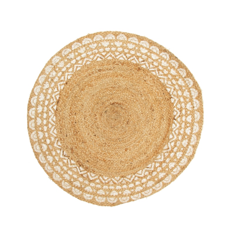 May include: Circular jute rug featuring a natural tan centre and a white patterned border. The rug has a woven texture and a decorative design around the edge. Suitable for indoor use, approx. 120cm in diameter.