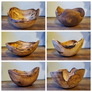 May include: A collection of six handcrafted wooden bowls. Each bowl is uniquely shaped with natural edges and a warm, earthy color palette. The wood grain patterns vary, showcasing the natural beauty of the material. These decorative bowls are ideal for home decor.