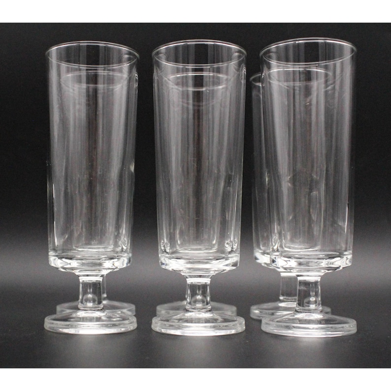 Puede incluir: Juego de seis vasos altos de vidrio transparente con tallo corto y base ancha.