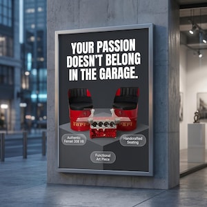 May include: A framed advertisement featuring furniture made from Ferrari parts. The ad includes two red chairs with black seats and a table with a red engine block base. Text reads "YOUR PASSION DOESN'T BELONG IN THE GARAGE."