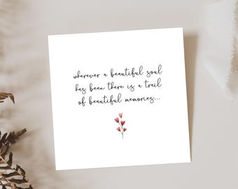 May include: A white card with the quote "Wherever a beautiful soul has been there is a trail of beautiful memories..." written in black cursive. A small watercolor illustration of a pink flower with five pink hearts is in the bottom center of the card.
