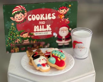 May include: A rectangular sign with green and red background featuring illustrations of elves, a Christmas tree, and Santa Claus with the text COOKIES AND MILK FOR SANTA CLAUS. A white plate holds four decorated cookies next to a glass of milk with a Santa face.