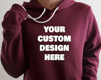 May include: A maroon hoodie with a white drawstring and the text "YOUR CUSTOM DESIGN HERE" printed on the front.