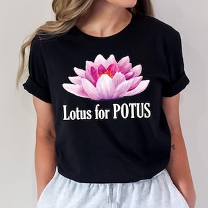 May include: Black t-shirt with a pink lotus flower graphic and the text "Lotus for POTUS" printed in white.