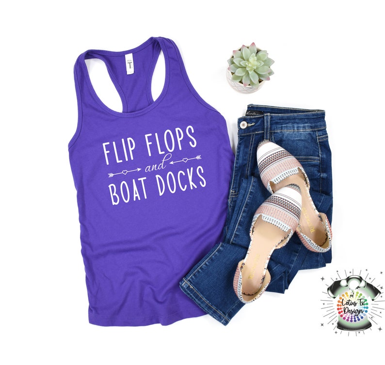May include: Purple tank top with the text "Flip Flops and Boat Docks" in white. The text is surrounded by arrows and hearts.