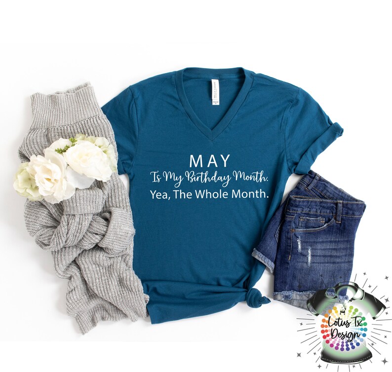 May include: Teal blue v-neck t-shirt with the text "MAY Is My Birthday Month. Yea, The Whole Month." in white lettering.