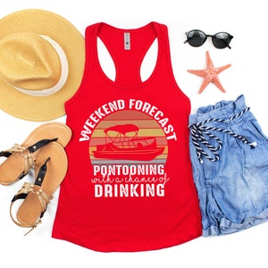 May include: Red tank top with a graphic of a sunset and a pontoon boat. The text on the graphic reads "Weekend Forecast: Pontooning with a chance of drinking".