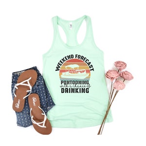 May include: A mint green tank top with a black graphic of a sunset with a pontoon boat and the text "Weekend Forecast Pontooning with a chance of Drinking".