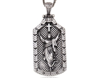 May include: Silver pendant necklace featuring a detailed depiction of Jesus Christ with a cross, surrounded by a laurel wreath design.