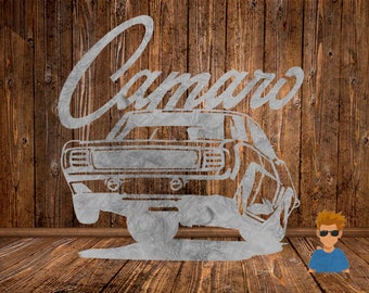 May include: A silver metal cutout of a classic car with the word "Camaro" above it. The car is on a wooden background.