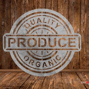 May include: A white stencil with the words "Quality Produce Organic" in a circle on a brown wooden background.
