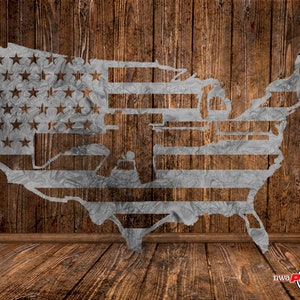 May include: A metal cutout of the United States of America in the shape of a flag with stars and stripes. The cutout is on a wooden background.