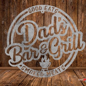May include: A metal sign with the text "Good Eats Dad's Bar & Grill Smoked Meats" in a circular design. The sign is a rustic style with a wood grain background.