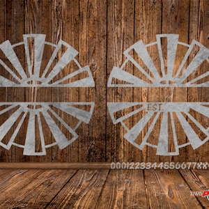 May include: Two metal windmill designs with a blank space for a name and the text "EST." on the bottom half of the design. The designs are on a wood background.