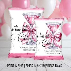 May include: Two white and pink party favor bags with a martini glass design and the text "a tini bit Older". The bags feature a pink bow and the text "CHAYLA'S 25TH BIRTHDAY SEPTEMBER 14, 20xx". Pink and white balloons are in the background.