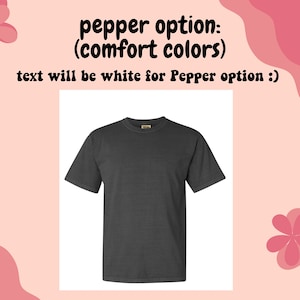 Pu&ograve; includere: Una maglietta grigia scura con collo rotondo. Il testo "pepper option: (comfort colors)" e "text will be white for Pepper option :)" &egrave; scritto sopra la maglietta.