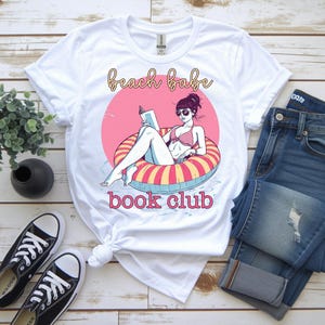 May include: A white ceramic mug with a black handle and the text "But First, Coffee" in a handwritten style. The mug is on a white surface. The mug is approximately 4 inches tall.