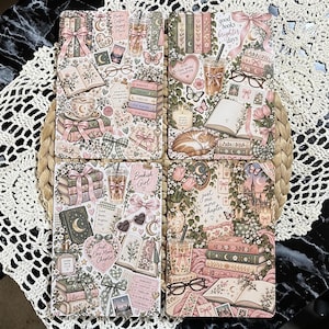 May include: Four rectangular coasters featuring a collage of illustrations including stacked books, iced coffee drinks, reading glasses, sleeping cats, pink bows, flowers, and text such as "good books brighter days" and "just one more chapter" in soft pastel tones.