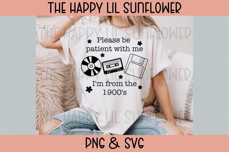 May include: A white short-sleeve t-shirt featuring black text that reads "Please be patient with me I'm from the 1900's" along with black graphic illustrations of a compact disc, a cassette tape, a floppy disk, and small flower icons.