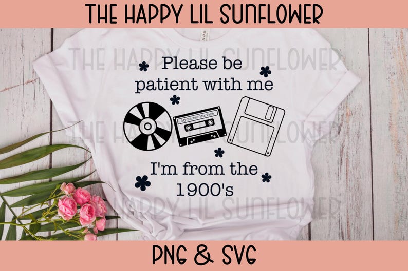 May include: A white t-shirt featuring black text that reads Please be patient with me I'm from the 1900's. The design includes black graphic illustrations of a compact disc, a cassette tape, and a floppy disk, accented by small flower icons.