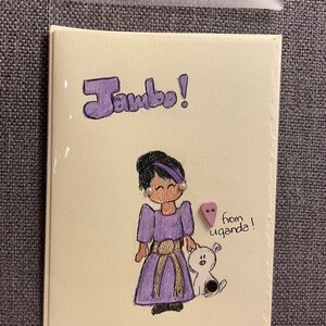 May include: A hand-drawn card with a purple-clad girl and a white dog. The card says "Jambo!" and "from uganda!" with a purple heart.
