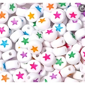 May include: White round beads with colorful star designs in orange, pink, green, blue, and purple. The beads have a hole through the center, suitable for stringing. These beads are ideal for jewelry making and craft projects.