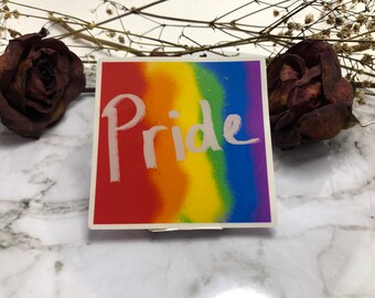 May include: A rainbow-colored sticker with the word "Pride" written in white paint.