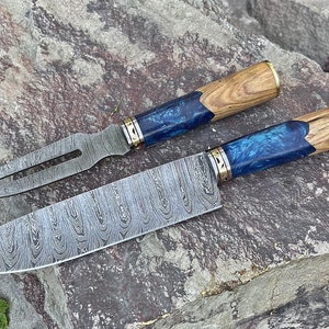 May include: A set of two kitchen knives with blue and wood handles. The blades are made of patterned steel.